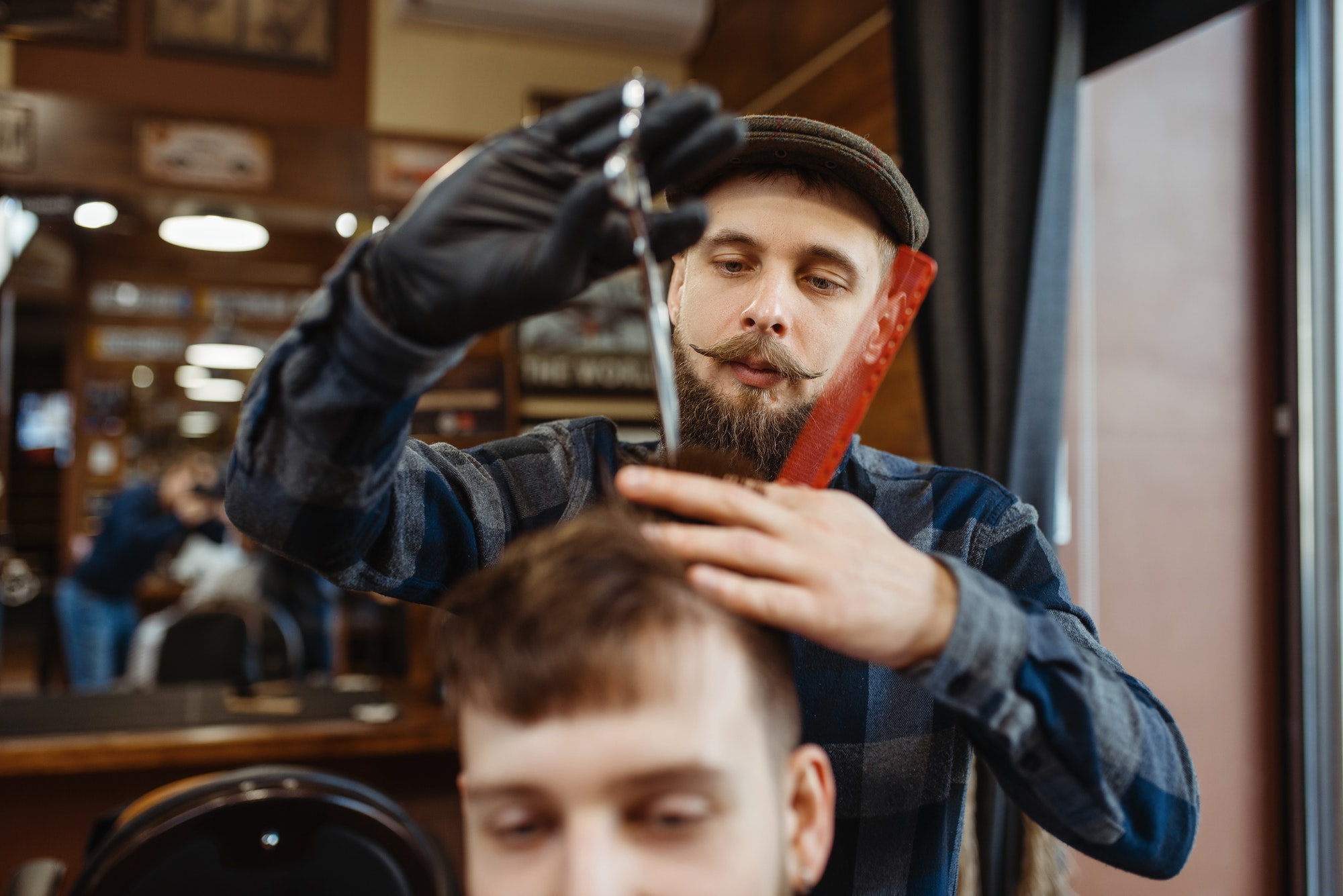 barber-makes-stylish-haircut-to-client-barbershop.jpg