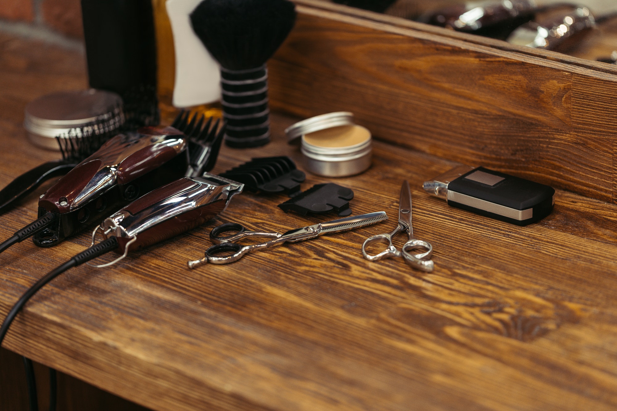 close-up-view-of-various-barber-tools-on-wooden-shelf-in-barbershop.jpg