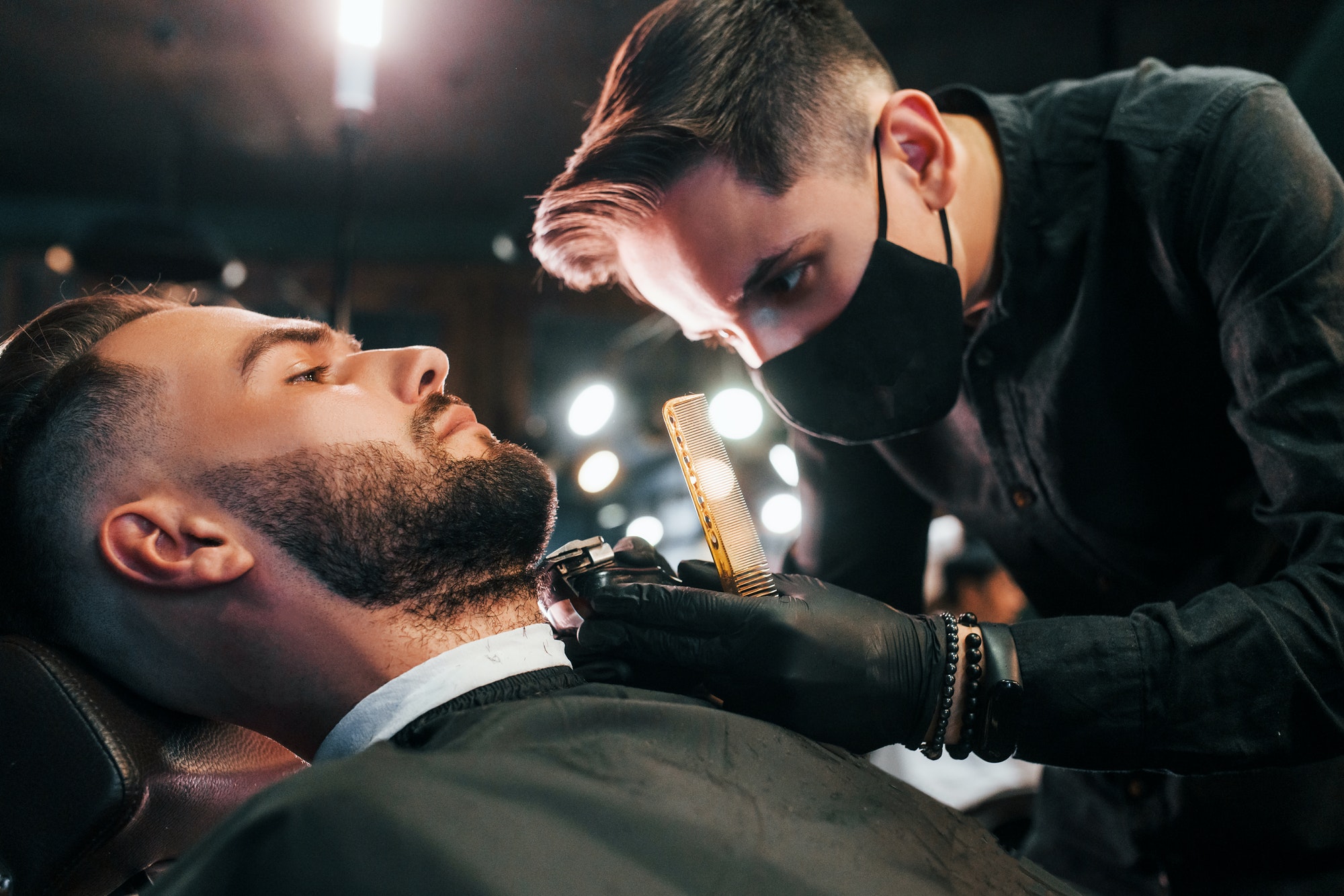 young-stylish-man-sitting-in-barbershop-1.jpg